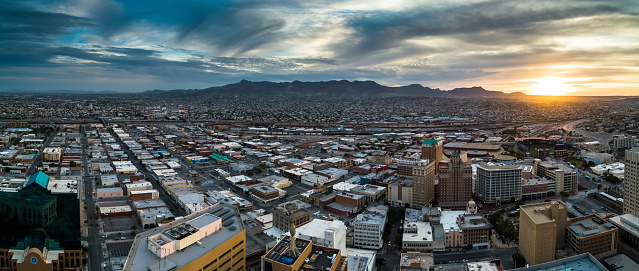 Aerial panorama of El Paso, Texas and Ciudad Juárez, Chihuahua on opposite sides of the US-Mexico border at sunset.
