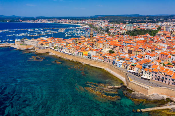 istock Aerial view over Alghero old town, cityscape Alghero view on a beautiful day with harbor and open sea in view. Alghero, Italy. Panoramic aerial view of Alghero, Sardinia, Italy. 1271414559
