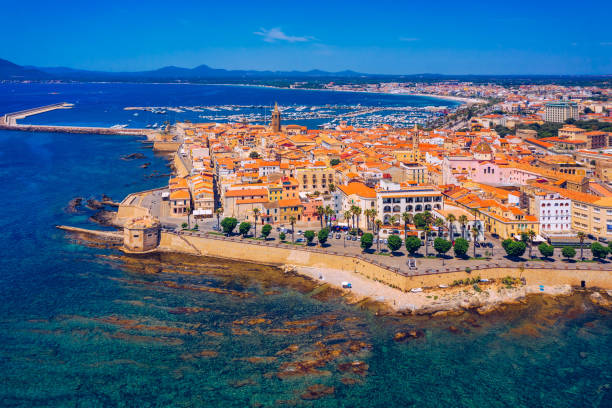 istock Aerial view over Alghero old town, cityscape Alghero view on a beautiful day with harbor and open sea in view. Alghero, Italy. Panoramic aerial view of Alghero, Sardinia, Italy. 1271414570