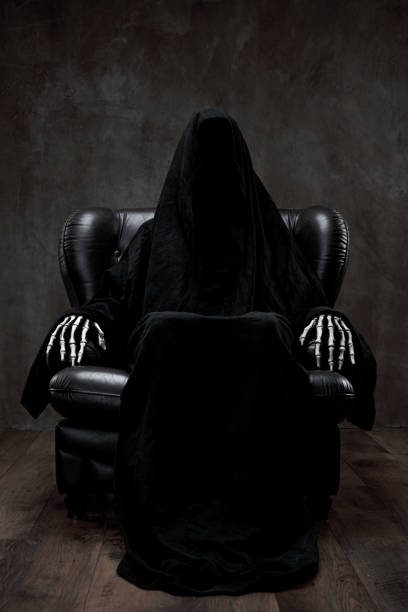 istock Grim Reaper sitting in a dark room patiently 1271414994