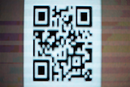 Pixelated QR code on lcd screen close up