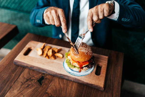 istock Senior businessman at restaurant table 1271415945