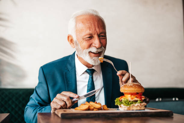 istock Senior businessman at restaurant table 1271415959