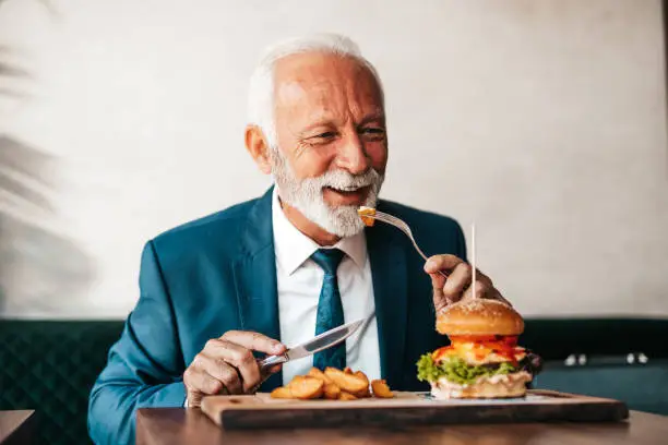 Photo of Senior businessman at restaurant table