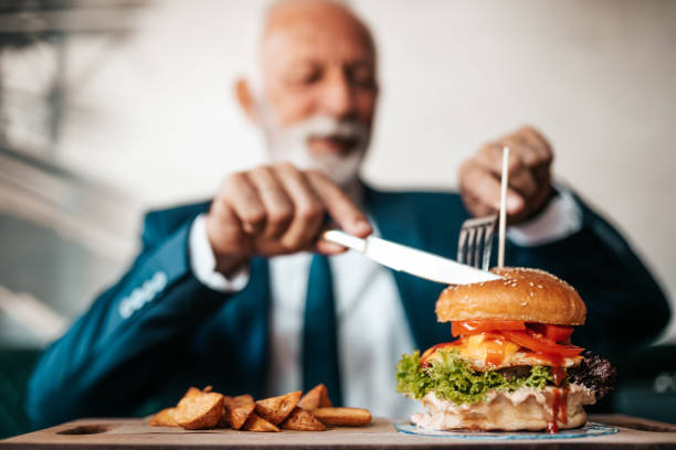 istock Senior businessman at restaurant table 1271415965
