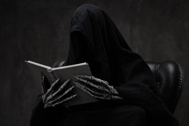 istock Grim Reaper reading a book in an armchair 1271416038