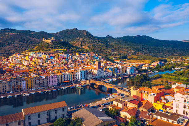 Aerial view of the beautiful village of Bosa with colored houses and a medieval castle. Bosa is located in the north-wesh of Sardinia, Italy. Aerial view of colorful houses in Bosa village, Sardegna. Aerial view of the beautiful village of Bosa with colored houses and a medieval castle. Bosa is located in the north-wesh of Sardinia, Italy. Aerial view of colorful houses in Bosa village, Sardegna. castelsardo photos stock pictures, royalty-free photos & images