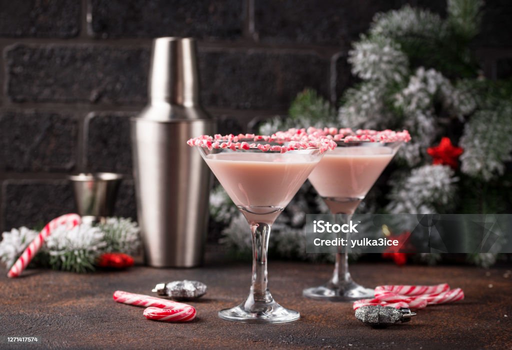 Pink peppermint martini with candy cane rim Pink peppermint martini with candy cane rim. Christmas cocktail Christmas Stock Photo