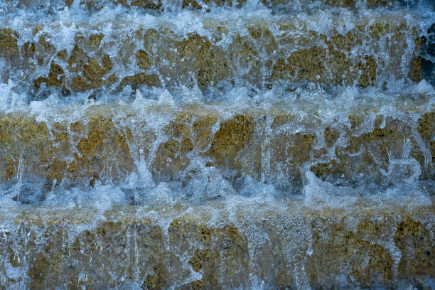 istock public stone stairs from the sidewalk with water running like a waterfall. 1271418308