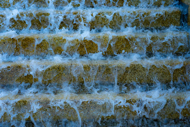 istock public stone stairs from the sidewalk with water running like a waterfall. 1271418311