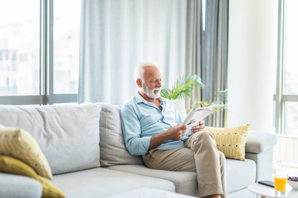 Senior man reading a magazine at home.