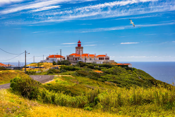 istock The lighthouse in Cabo da Roca. Cliffs and rocks on the Atlantic ocean coast in Sintra in a beautiful summer day, Portugal. Cabo da Roca, Portugal. Lighthouse and cliffs over Atlantic Ocean. 1271420840