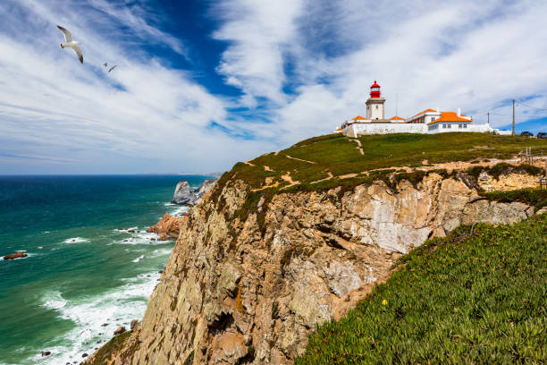 istock The lighthouse in Cabo da Roca. Cliffs and rocks on the Atlantic ocean coast in Sintra in a beautiful summer day, Portugal. Cabo da Roca, Portugal. Lighthouse and cliffs over Atlantic Ocean. 1271420901