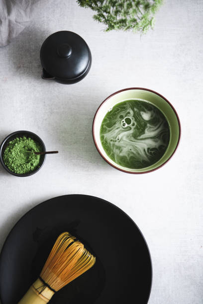 Matcha tea with kettle , chasen and traditional japanese tea cup.