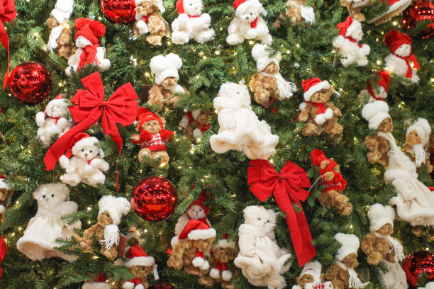 Christmas background with a Christmas tree decorated with different bears, balls and bows.