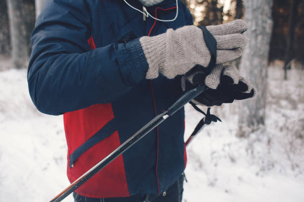istock Mature man putting on skis on snowy hill 1271425489