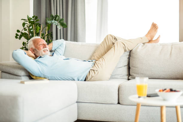 istock Happy senior man relaxing on sofa. 1271427648