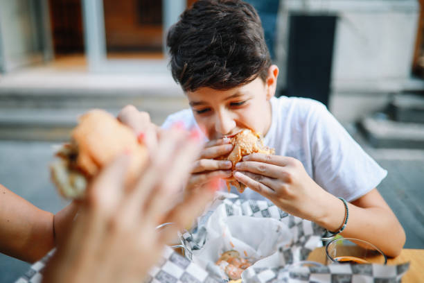 istock Young boy having hamburgers with his mom 1271428623