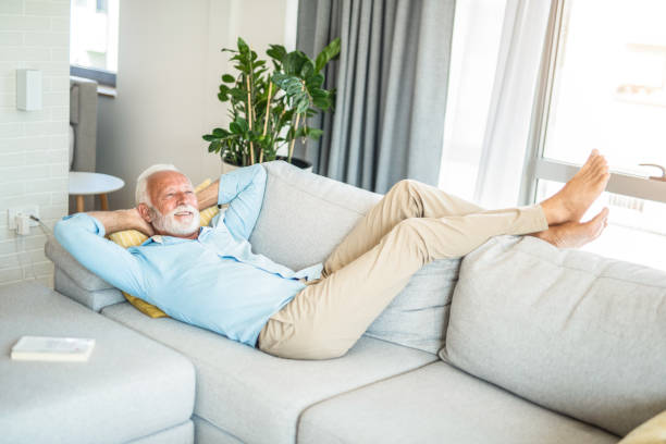 istock Happy senior man relaxing on sofa. 1271428636