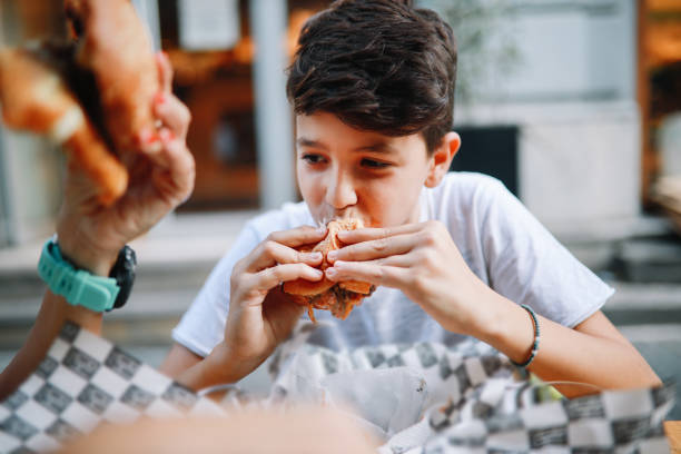 istock Young boy having hamburgers with his mom 1271428671