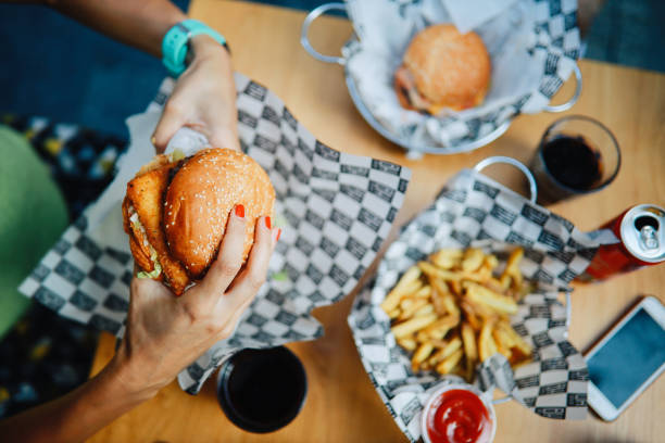 istock Overhead image of people eating burgers 1271429456
