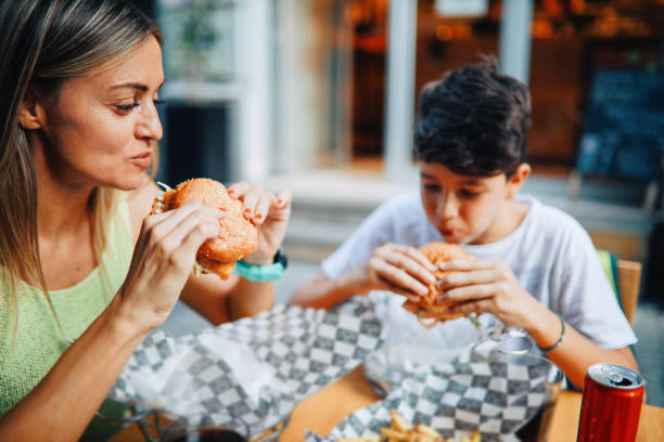 istock Mom taking her kid to the burger place 1271430689