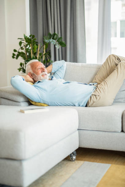 istock Happy senior man relaxing on sofa. 1271430942