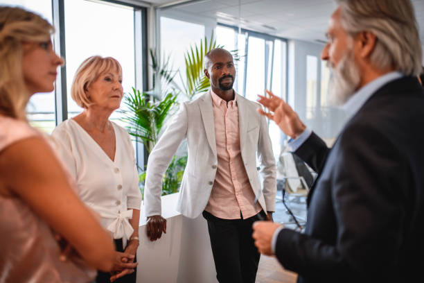 istock Mature Business Professional Talking With Associates 1271430990