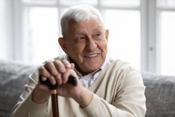 istock Smiling old disabled man resting on cozy couch. 1271431617