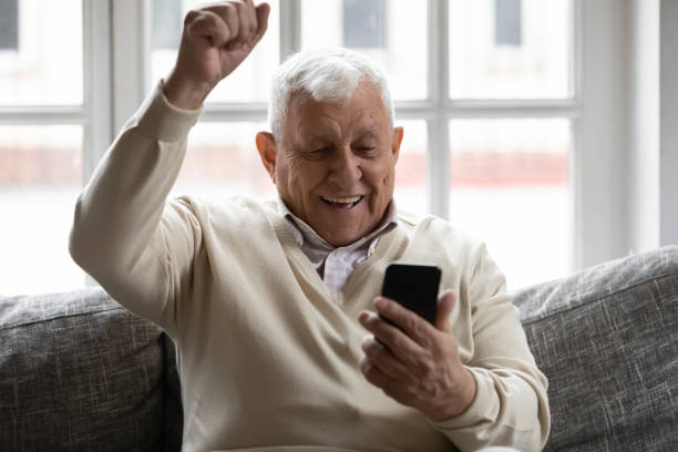 istock Excited elderly mature retired man celebrating online lottery win. 1271431620