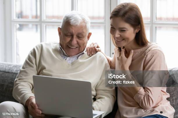 Happy Different Generations Family Watching Film On Computer Stock Photo - Download Image Now