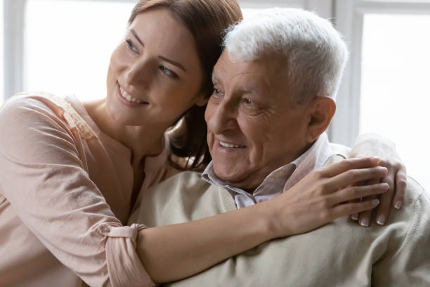 istock Affectionate young woman cuddling loving positive older retired daddy. 1271431630