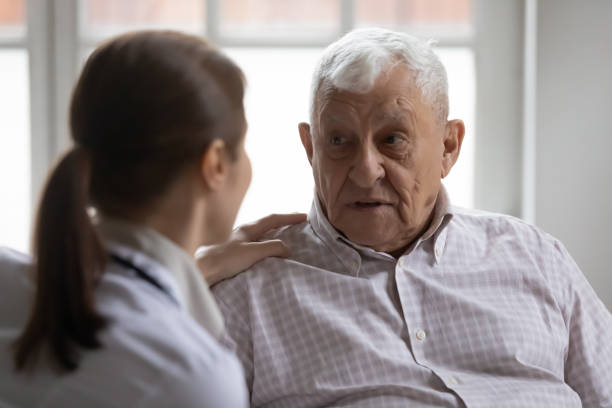 istock Sad older 80s man sharing health problems with young nurse. 1271431646