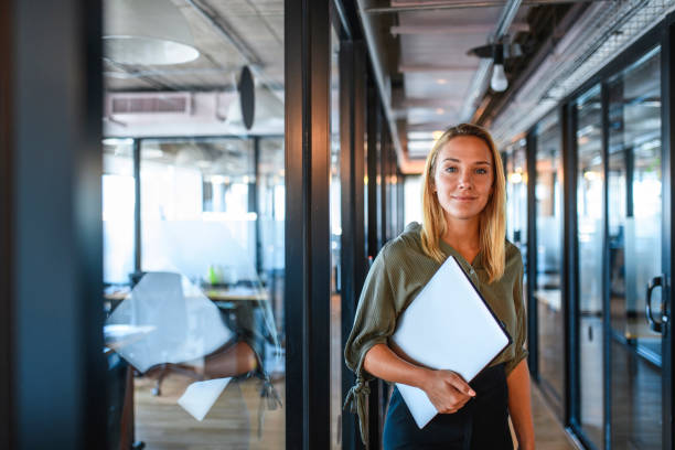 istock Young Businesswoman with Digital Tablet in Office Hallway 1271431714