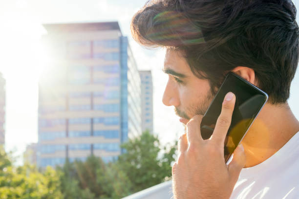 istock young man talking on smartphone in front of city 1271432764