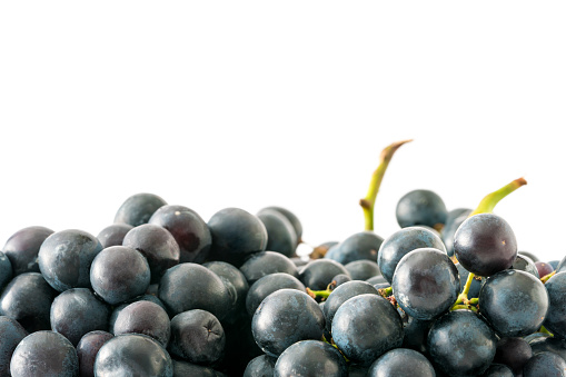 Black grapes on white background