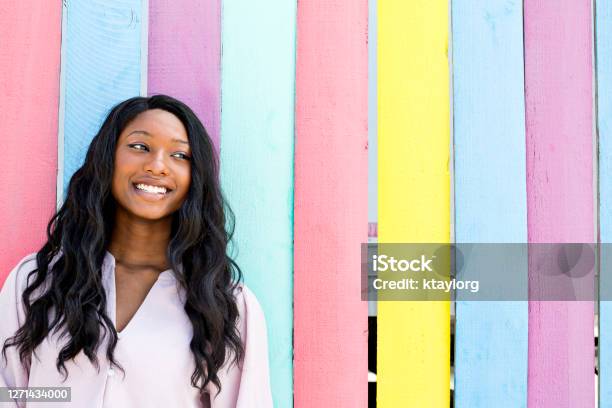 Confident And Stunning Teen Outdoors Infront Of Neoncolored Wall Stock Photo - Download Image Now