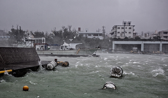 On 08/24/2015 during a typhoon in Yomitan boat port in Okinawa, Japan rough seas can be seen inside the port.