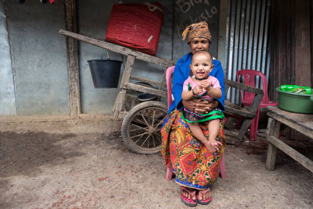 Maubisse / Timor Leste - July 25, 2018: Timorese woman with small child in interior town
