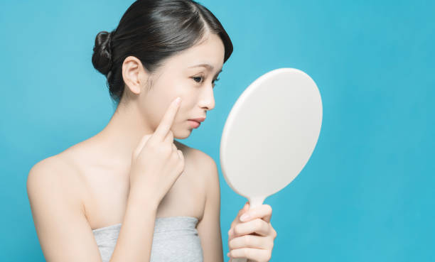 istock Asian girl checking her skin. 1271443286