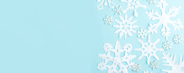 istock Christmas wallpaper with empty space for text. White Paper snowflakes on blue background. Blue winter holiday background with handmade snow, Xmas, New 2021 Year holiday banner 1271444351
