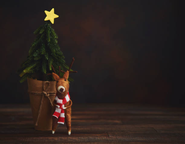 istock Cute Christmas Background with Tree and Felt Reindeer 1271445923
