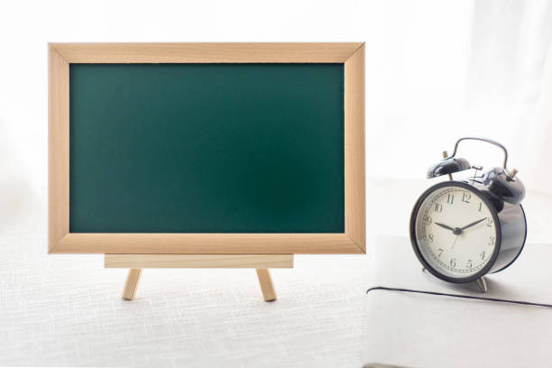 istock The blackboard and alarm clock 1271453381