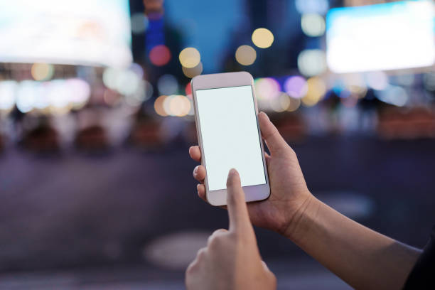 istock Using smart phone on street at night. 1271453508