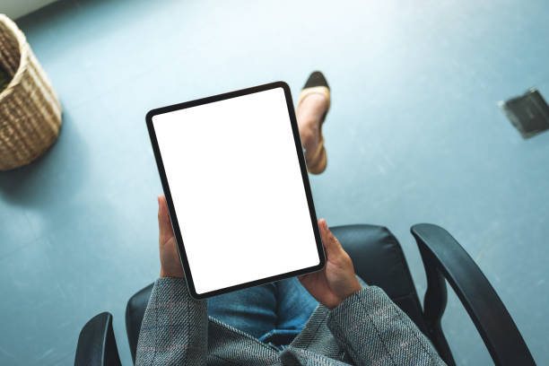 istock a business woman holding digital tablet with blank white desktop screen 1271453624