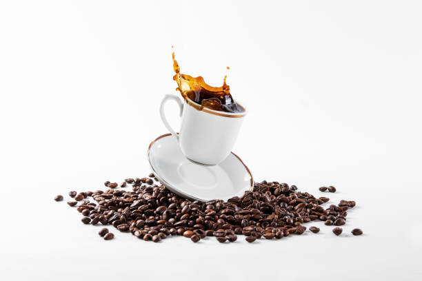 istock Cup of coffee falling on beans and spilling coffee 1271455421