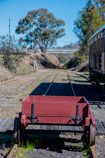istock Old red disused railway carriage with tracks into distance. 1271456078