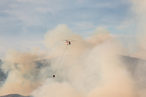 At 0% containment, the fire has burned more than 10,000 acres as of Tuesday night with red flag warnings issued due to the windy conditions. Super Scooper amphibious firefighting aircraft picking up water from a lake. \