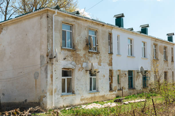 istock Old dilapidated, weather-beaten house that needs to be renovated. Housing problem 1271458993