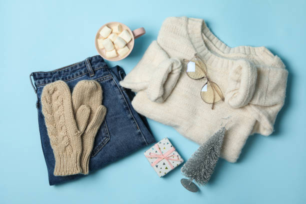 istock Winter concept with sweater and gift box on blue background 1271465023